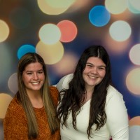 Two girls smiling at the Photo Booth.